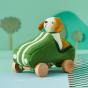 Olli Ella Holdie Dog-go Racer Boy in a green felt racing car with wooden wheels and white stripes