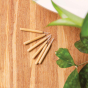 Hydrophil Bamboo Interdental sticks scattered on a wooden worktop.