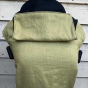 Integra eco-friendly chartreuse baby carrier in front of a white wooden fence