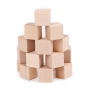 Just blocks plastic free wooden toy building cubes stacked in a curved pyramid shape on a white background