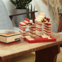 Kapla plastic-free wooden stacking blocks built into two building shapes on a wooden coffee table