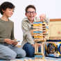 Two boys kneeling down making a tower with the Kapla plastic-free wooden toy blocks