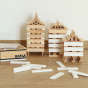3 towers made from Kapla plastic-free wooden stacking shapes on a wooden floor