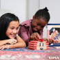 Close up of two girls making a tower with the Kapla Waldorf wooden toy blocks on a red and blue carpet