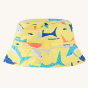 Frugi Harbour Swim Hat - Banana Sharks. A banana yellow sun hat with colourful shark print details, on a cream back ground. The hat is made from quick drying, recycled fabric that meets UPF 50+. 