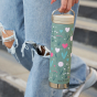 An adult carrying the Klean Kanteen TKWide Limited Edition Insulated 20oz / 592ml Twist Cap - Flowers by the loop cap
