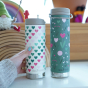 Both Klean Kanteen Limited Edition TK Wide's stood next to each other in a play room, with the Heart TKwide being held in an adults hand