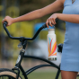 A person holding their Klean Kanteen 20oz Insulated Classic Loop Bottle 2023 Retro Swish whilst holding their bike handles