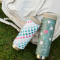 Limited Edition Klean Kanteen TKWide hearts and flowers, laid next to each other on a cream bag which is on grass