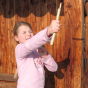 Child demonstrating how to launch the Kraul Super Bamboo Dragonfly.