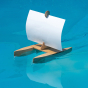 Kraul Kari Sailing Boat Kit  with a white sail, on the water.
