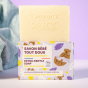Lamazuna Extra Gentle Natural hypoallergenic and fragrance free Baby Soap on top of the box with a towel in the background on a purple background 