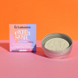 Lamazuna Extra Soft Organic Shampoo Bar for All Hair Types, in a Lamazuna Metal Tin and next to the box, on an orange background and pink table