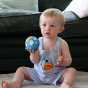 Young child holding the the Lanco day and night moulded natural rubber ball toy 