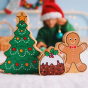 Lanka kade plastic free wooden christmas pudding toy on a white sheet in front of a Lanka kade christmas tree and gingerbread man