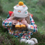 A young child wears the LGR Flower Knitted Hat in an outdoor setting.