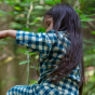 A child wears the LGR Blue Check Classic Button-Up Pyjamas in an outdoor setting.