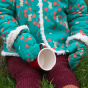 A young child wears the LGR Forest Walk Sherpa Mittens in an outdoor setting.