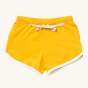 Gold Run Around Shorts. Made from GOTS Organic Cotton, these shorts are a rich gold colour, with off white piping on the legs, drawstring and side pockets for treasures