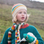 A child wears the LGR Rainbow Striped Beanie Hat outdoors.