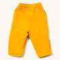 Kids reversible yellow and blue checkered LGR trousers laid out on a white background