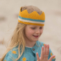 Close up of young girl wearing an LGR knitted organic cotton crown on her head