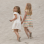2 girls on a beach wearing the LGR organic cotton kids rainbow print dresses