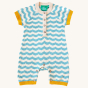 Little Green Radicals Sail Away Knitted Shortie. Made from GOTS Organic Cotton, this shortie has a beautiful blue and cream wavy stripe with yellow arm and leg cuffs, with button on the chest and around the crotch and feet for easy dressing