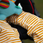Child wearing the Little green Radicals Adaptive Extra Long Gold Striped Joggers showing a close up of the knee patches