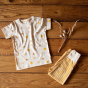 Flatlay featuring the Little Green Radicals Adaptive Easy Feeding Sunshine & Rainbows T-Shirt and gold striped joggers 