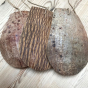 Image of three LoofCo Washing-Up Scrapers showing variation in grain on the coconut husks placed on a wooden background