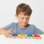Child playing with the sustainably sourced waldorf wooded supercar toys on a white table