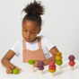 Girl playing with the Lubulona plastic free stacking autumn tree toys on a white table