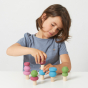 Child playing with the Lubulona plastic free stacking spring trees set on a white table