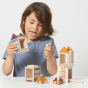 Girl playing with the eco-friendly stacking Lubulona Autumn town play set on a white table