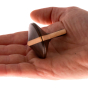 Mader Charlie Finger Spinning Top held in an adult hand against a plain background.