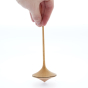 Close up of a hand holding a Mader handmade Trumpo spinning top on a white background
