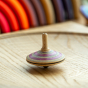 Mader Fado Maple Spinning Top on a spinning plate.