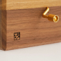 A close up of the Mader Logo and handle of the Mader Kreiselmanufaktur Luna Music Box.
