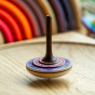 Mader Bonbon Spinning Top sitting on a spinning plate.