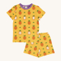 Maxomorra Children's Organic Cotton Pineapple Short Sleeve Pyjama Set. A bright, sunny yellow fabric with whole and half cut pineapple print, and purple piping around the collar of the pyjama top