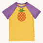Maxomorra Children's Organic Cotton Pineapple Raglan Short Sleeve Top. A bright, yellow fabric with a whole pineapple print on the chest, purple piping around the neck and purple sleeves