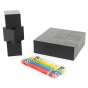 Naef eco-friendly wooden colorem colouring cubes laid out on a white background next to some coloured crayons