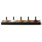 Naef 5 eco-friendly wooden spinning top toy set in their black stand on a white background 