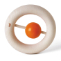 Naef's wooden Kauring baby teether stood up on end highlighting donut design with small orange rattle in the centre. Toy is placed on a white background. 