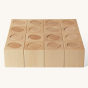 Naef Ligno precision manufactured natural wooden toy blocks laid out in a square on a beige background
