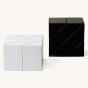 Naef black and white ponte premium wooden toy shapes stacked in 2 cubes on a beige background