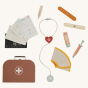 The Olli Ella Dinkum Dog Vet Set is a brown Vet's bag containing a toy stethoscope, thermometer, plasters, syringe, cream tube, dog cone, and Vet's notes.   