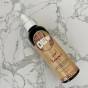 Olew natural hair curl keeper spray on a white marble background