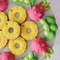 6x Oli & Carol Ananas the Pineapple natural rubber teether along with other items create a pattern on a marble plate